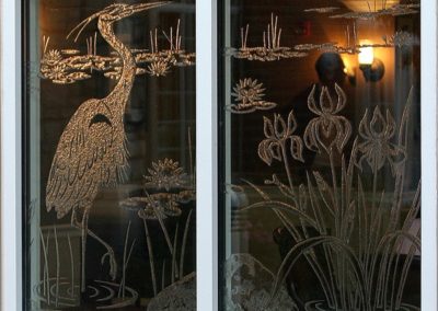 Etched glass adds intrigue in the lounge area with nature and wildlife scenes