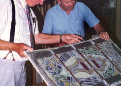 Panels are examined closely to determine the correct method of restoration of the historic Tiffany windows